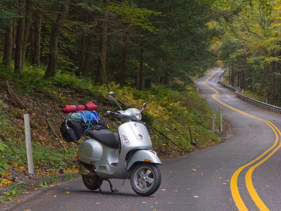 Vespa GTS scooter on winding road near Hyner View