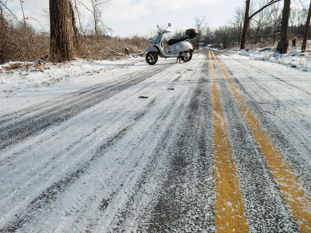 Vespa GTS scooter on snow covered road