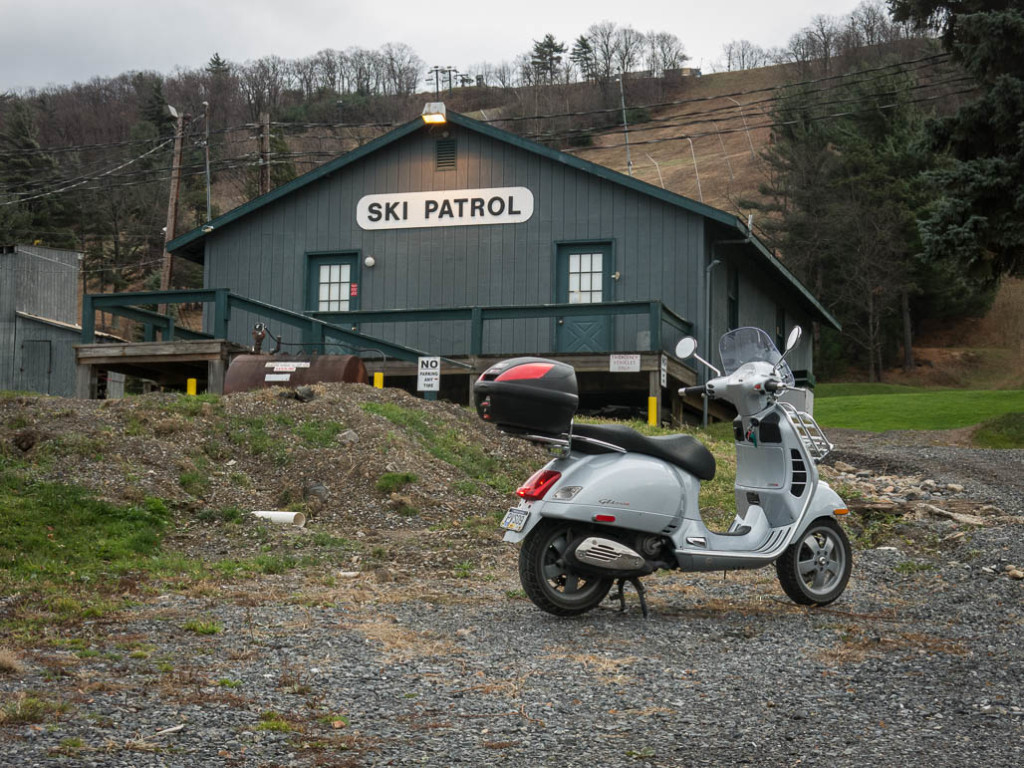 Vespa GTS scooter parked outside the Ski Patrol office