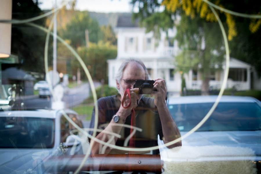 Reflection of photographer in window