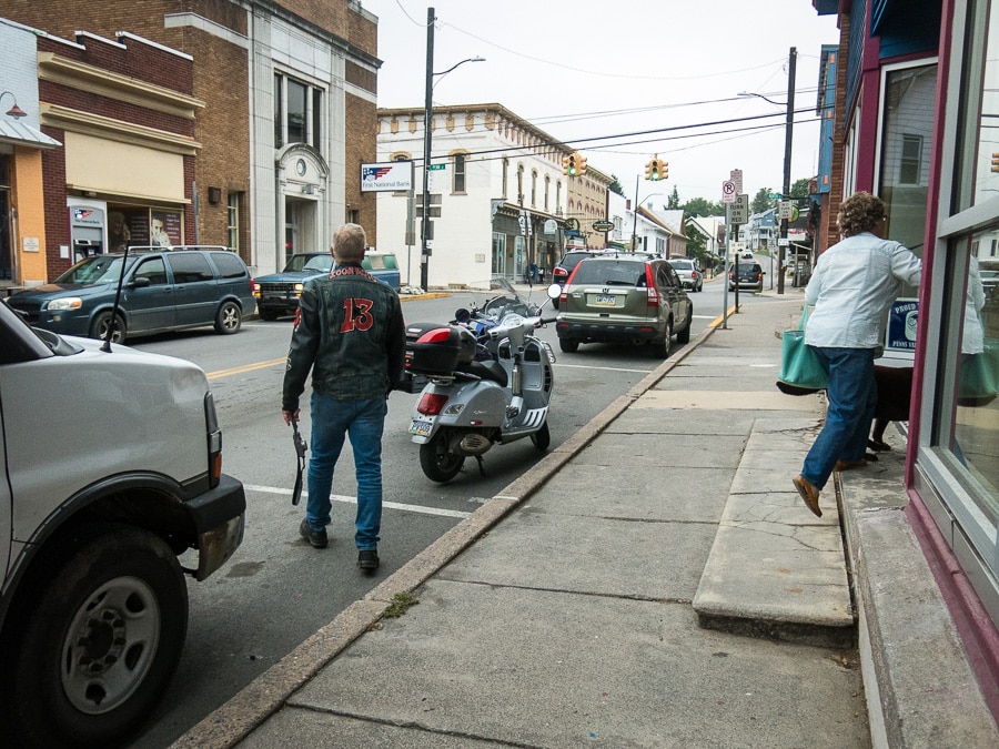 Paul Ruby walking to his BMW motorcycle parked on the street in Millheim, Pennsylvania