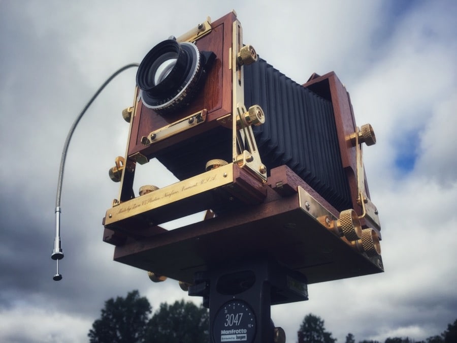 Wooden view camera in field.