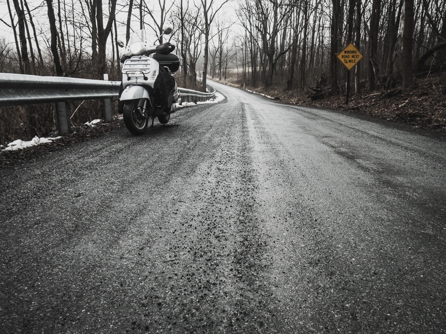 Vespa and gravel covered winter road