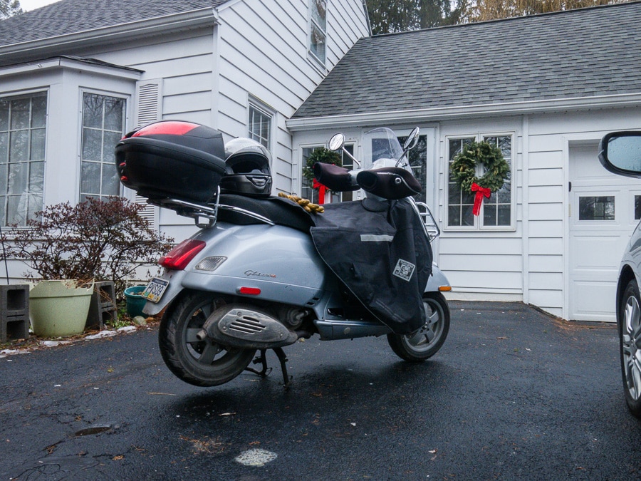 Vespa GTS scooter parked in a driveway