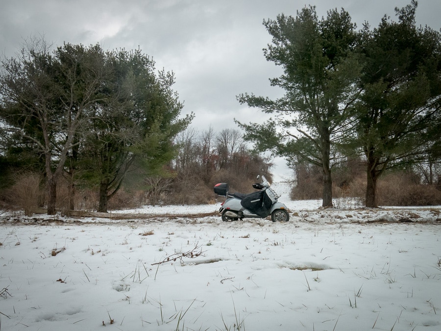Vespa GTS scooter on a rural road in winter
