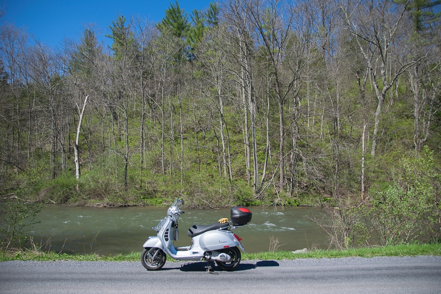 Vespa GTS scooter along a stream