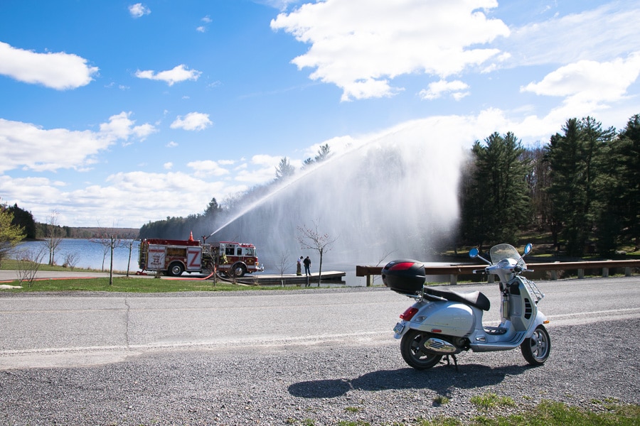 Firetruck with water cannon operating at a lake.