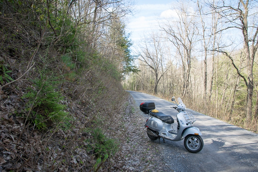 Vespa GTS scooter on a gravel road.