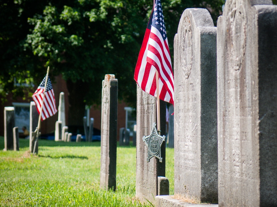 flags and tombstones in cemetery
