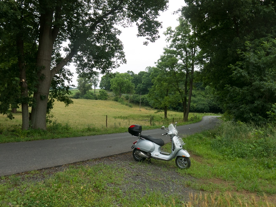 Vespa scooter along a country road