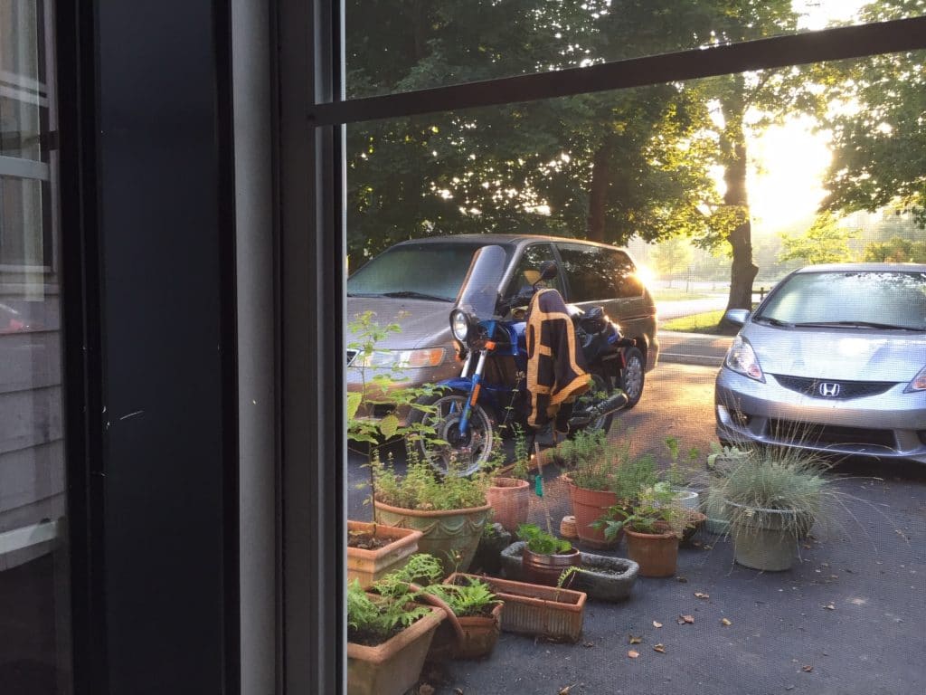 BMW K65 motorcycle in a driveway at sunrise