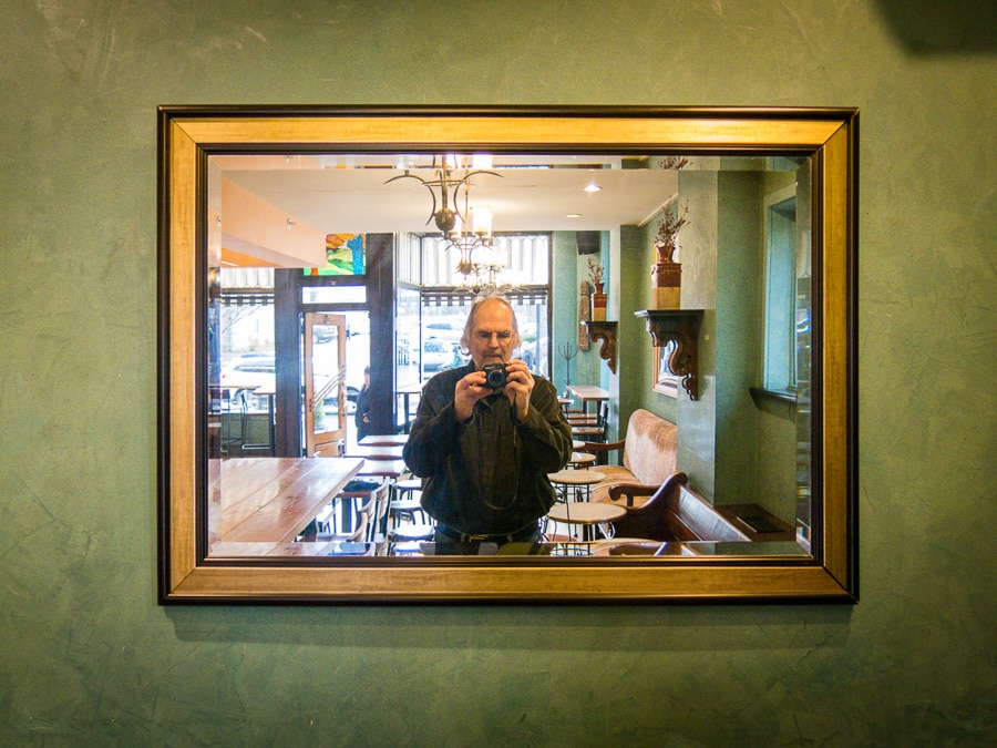 Steve Williams portrait in a mirror at Saint's Cafe