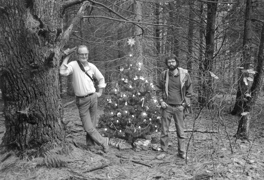 Jim McClure and Steve Williams with a Christmas tree in a forest