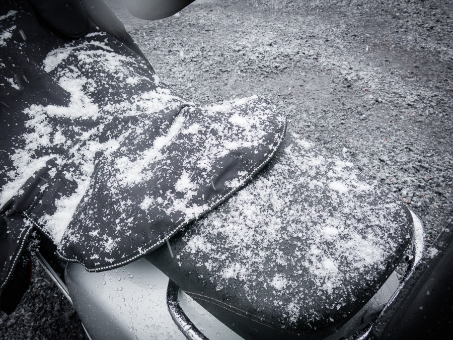 Seat of Vespa GTS scooter covered in snow