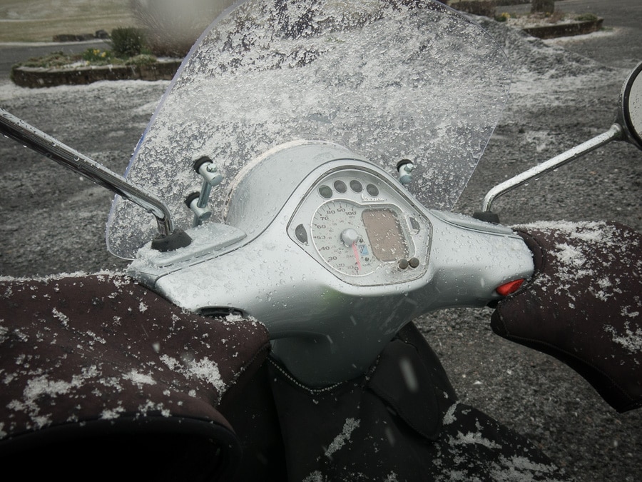 Snow sticking to windscreen of Vespa scooter