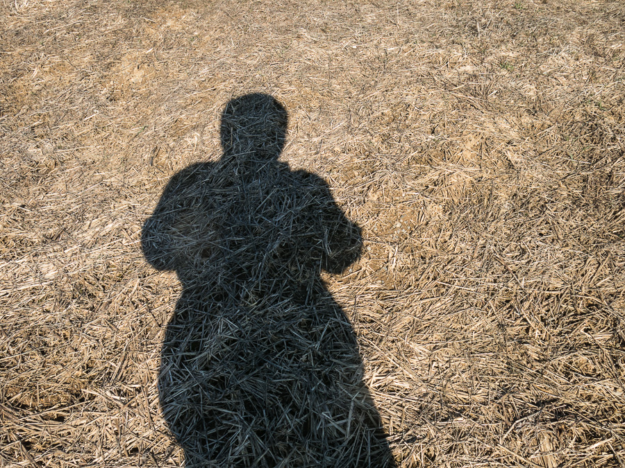 Shadow of man on winter farm field