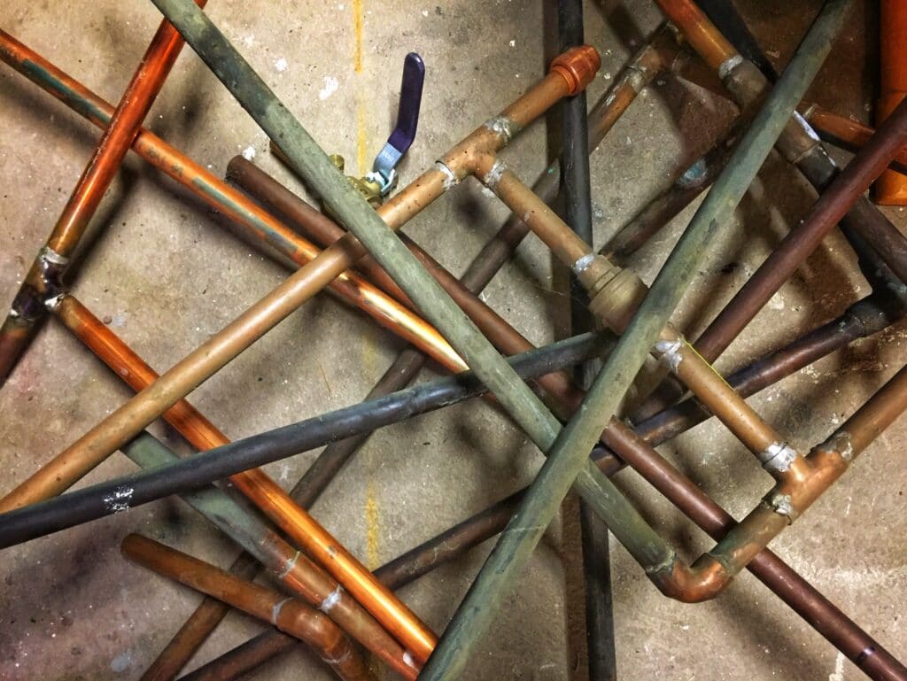 Pile of old copper water pipes.
