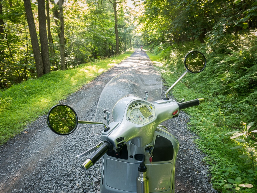 Vespa GTS scooter on a gravel road.