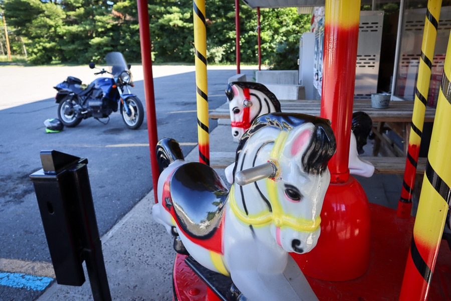 Merry-go-round horses and motorcycle.