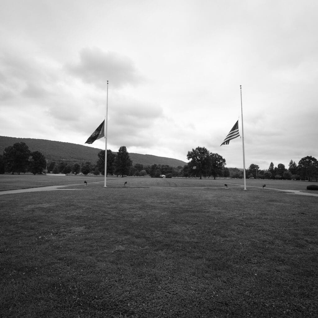 United States and Pennsylvania flags at half mast.