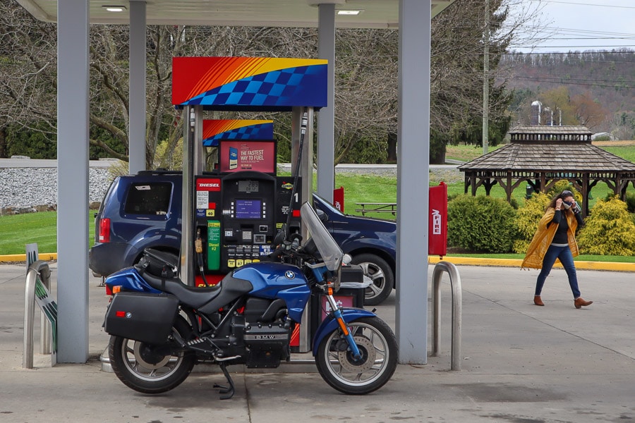 BMW K75 motorcycle at a gas pump.