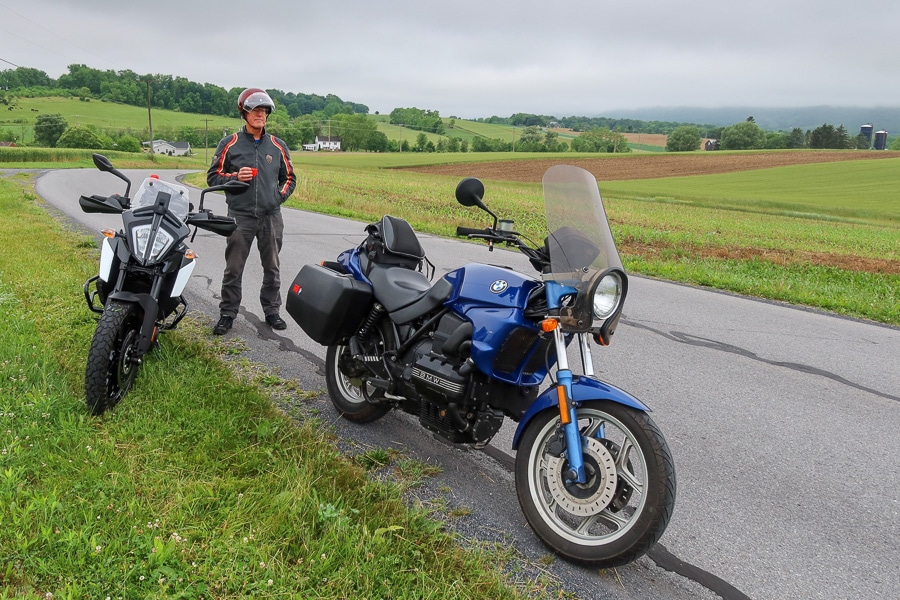 BMW K75 and KTM390 Adventure motorcycle stopped along a rural road.