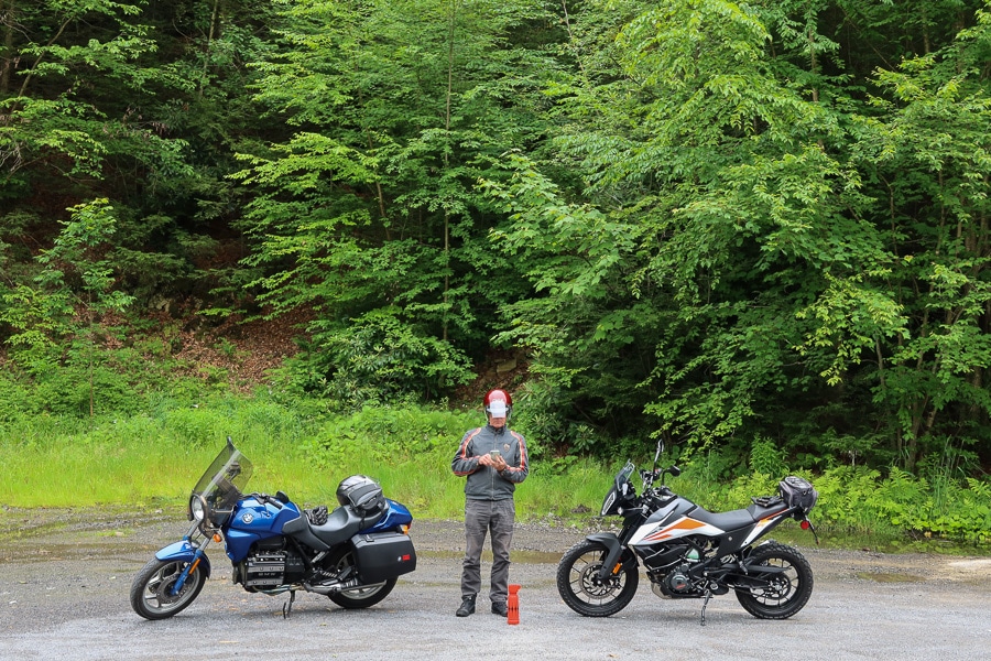 BMW K75 and KTM390 Adventure motorcycle stopped along a forest road.