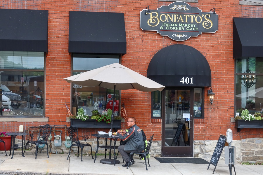 Man sitting at an outdoor table at Bonfatto's Corner Cafe.