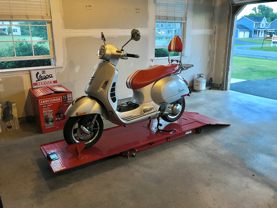 Vespa scooter on motorcycle lift table