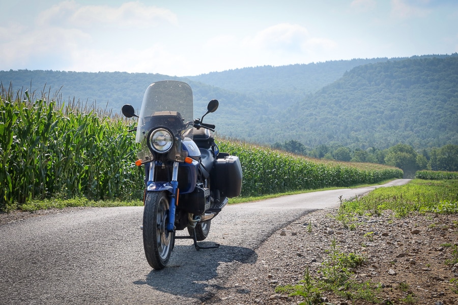 BMW K75C motorcycle on farm road.