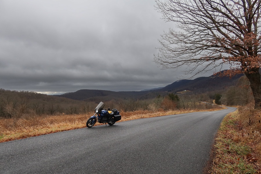BMW K75 motorcycle on rural road on a winter day.