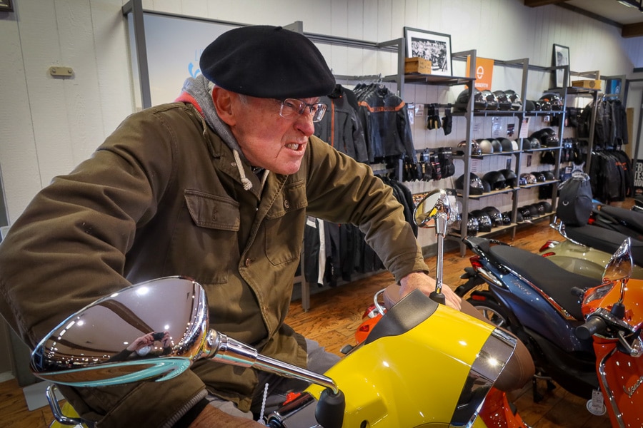 Paul Ruby on a Vespa scooter.