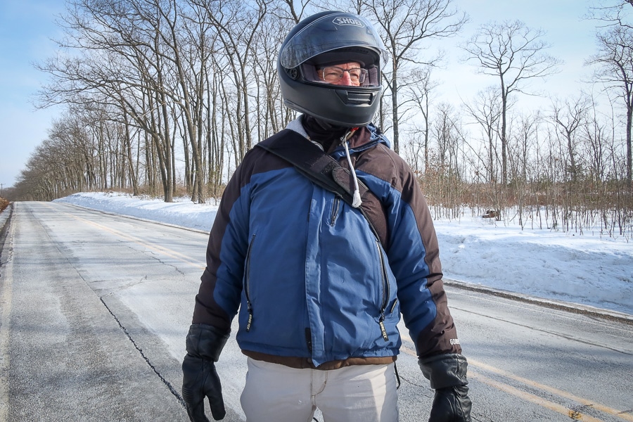Motorcycle rider Paul Ruby standing in the road