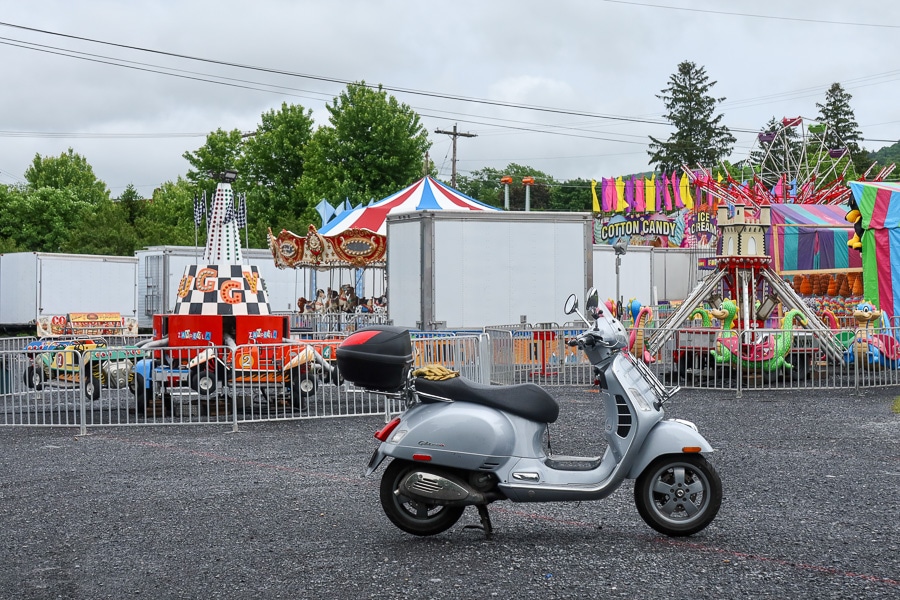 Vespa GTS scooter parked at the Boalsburg Fireman's Carnival site in early morning.