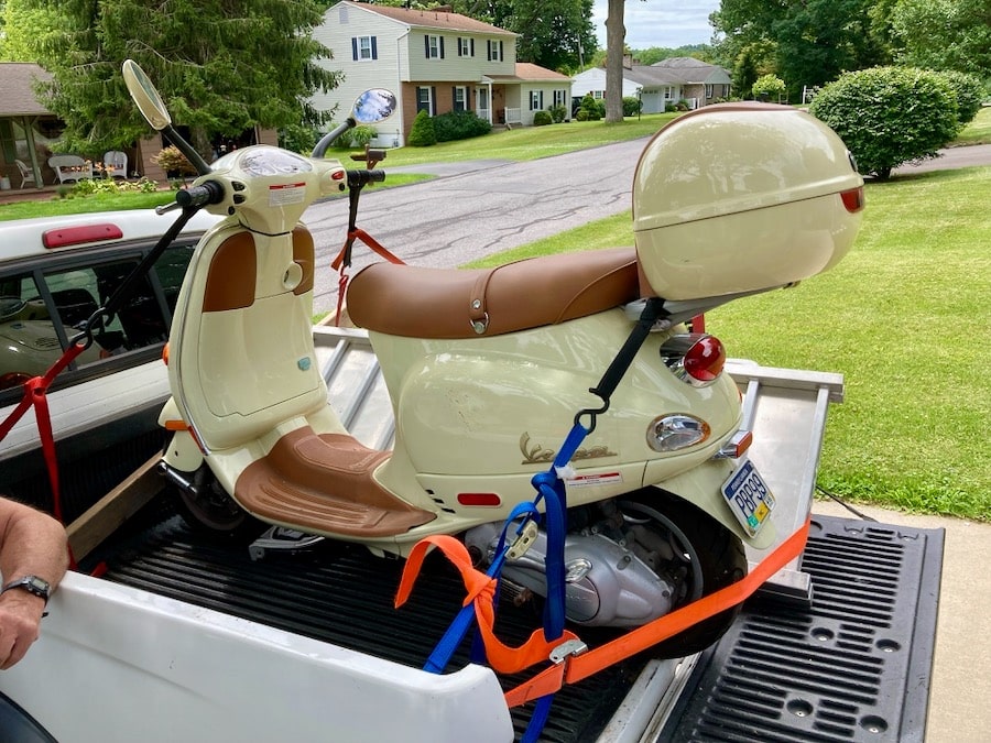 2004 Vespa ET4 strapped onto the bed of a pickup truck.
