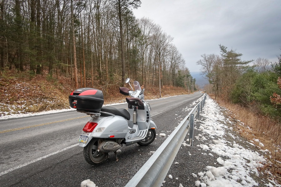 Vespa GTS scooter along a winter road.