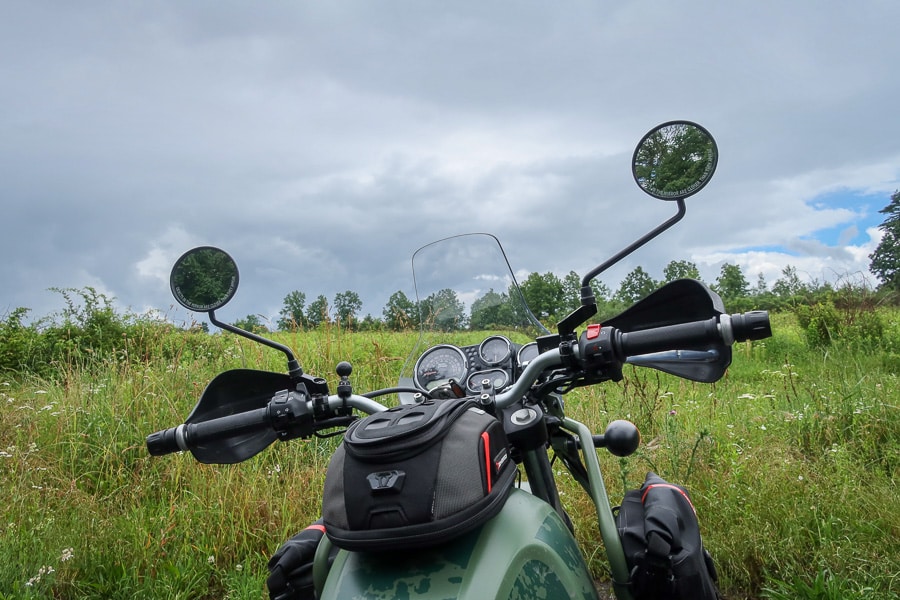 Looking out over the handlebars of a 2022 Royal Enfield Himalayan motorcycle.