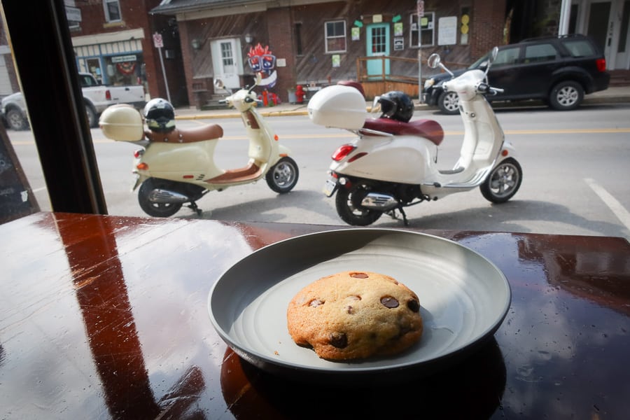 View from the cafe window of two Vespa scooters.