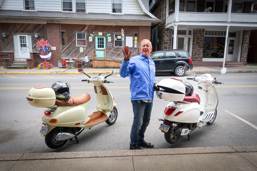 Paul Ruby between two Vespa scooters.