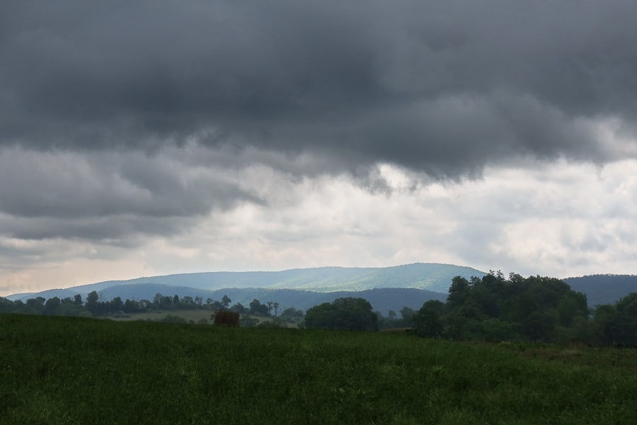 Dark sky over a panoramic rural scene.