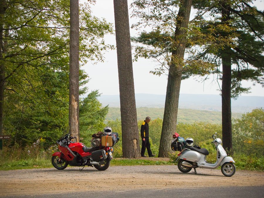 A scooter and motorcycle parked in the Pennsylvania Wilds.