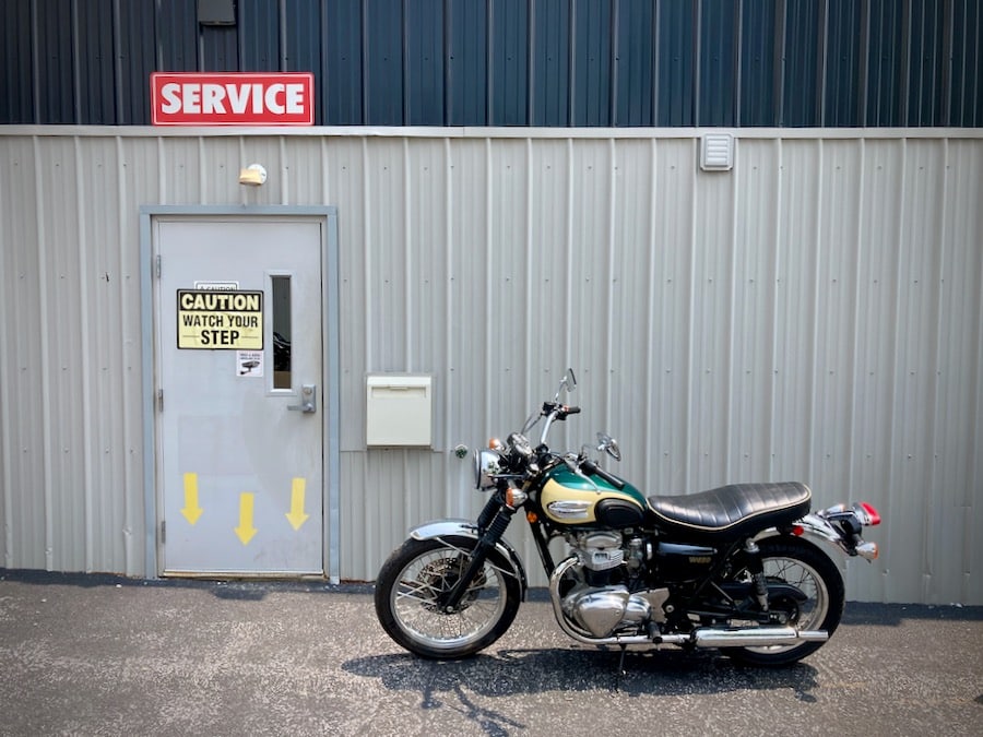 2001 Kawasaki W650 parked at a motorcycle dealership.