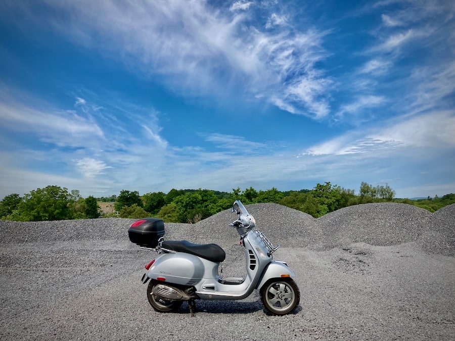 Vespa GTS scooter parked at a quarry.