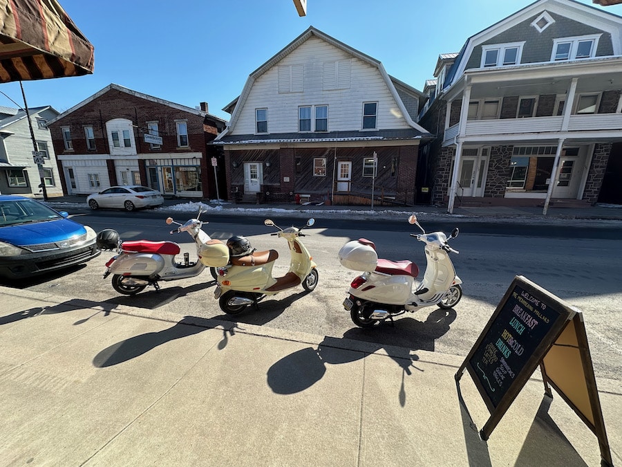 Three Vespa scooters parked in Millheim, Pennsylvania.