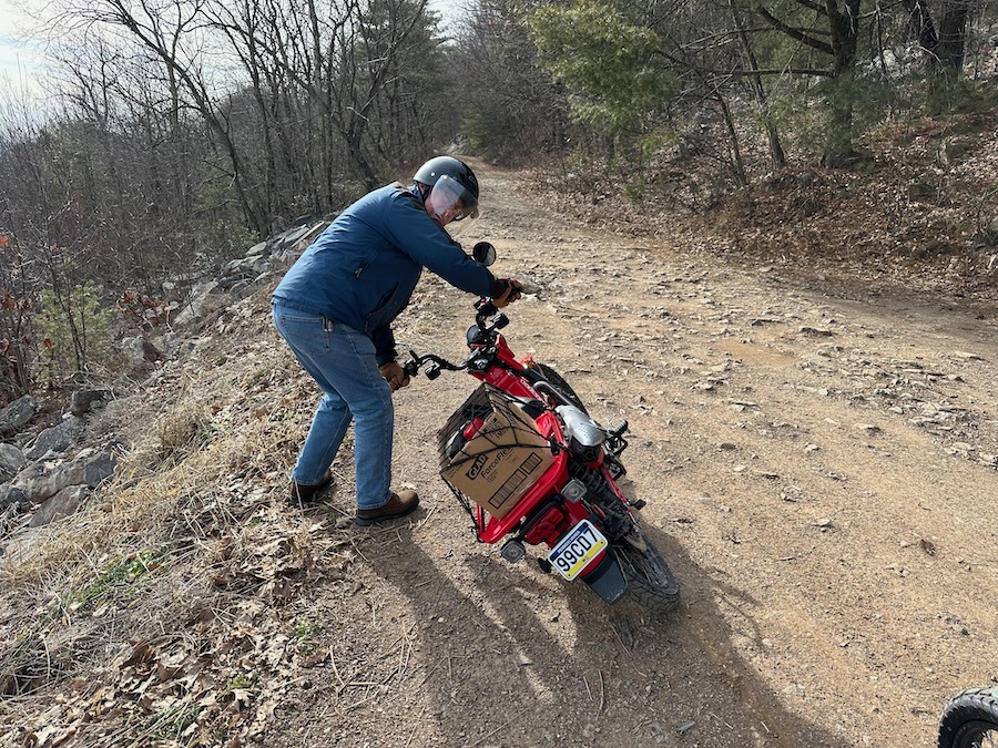 Lifting a Honda Trail 125 off the ground