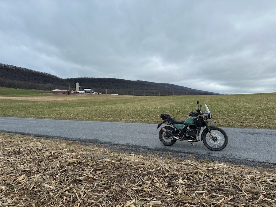 Royal Enfield Himalayan motorcycle on a rural road.