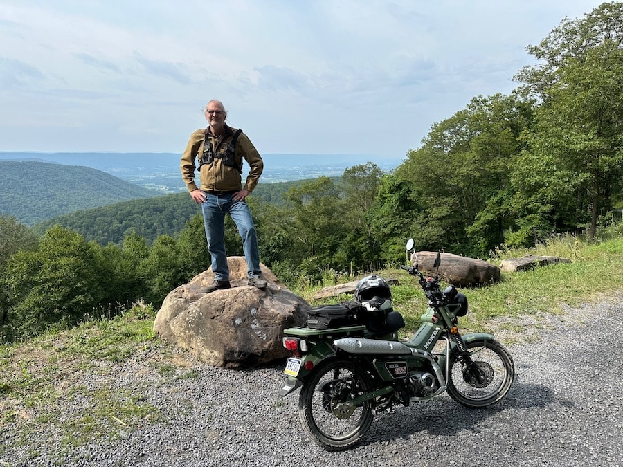 Steve Williams at the Big Valley Vista with his Honda Trail 125 motorcycle.