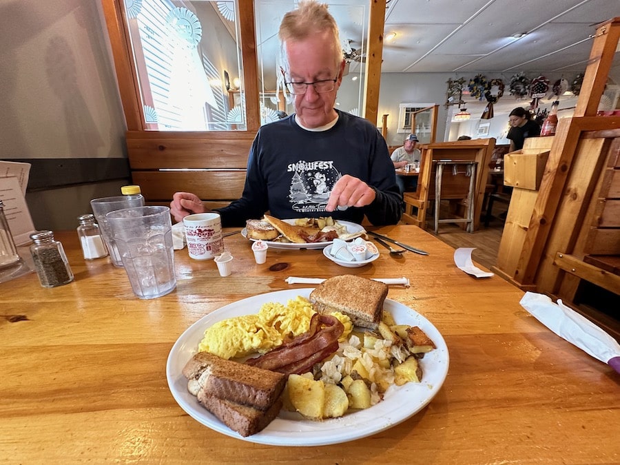 Man eating breakfast in a restaurant.