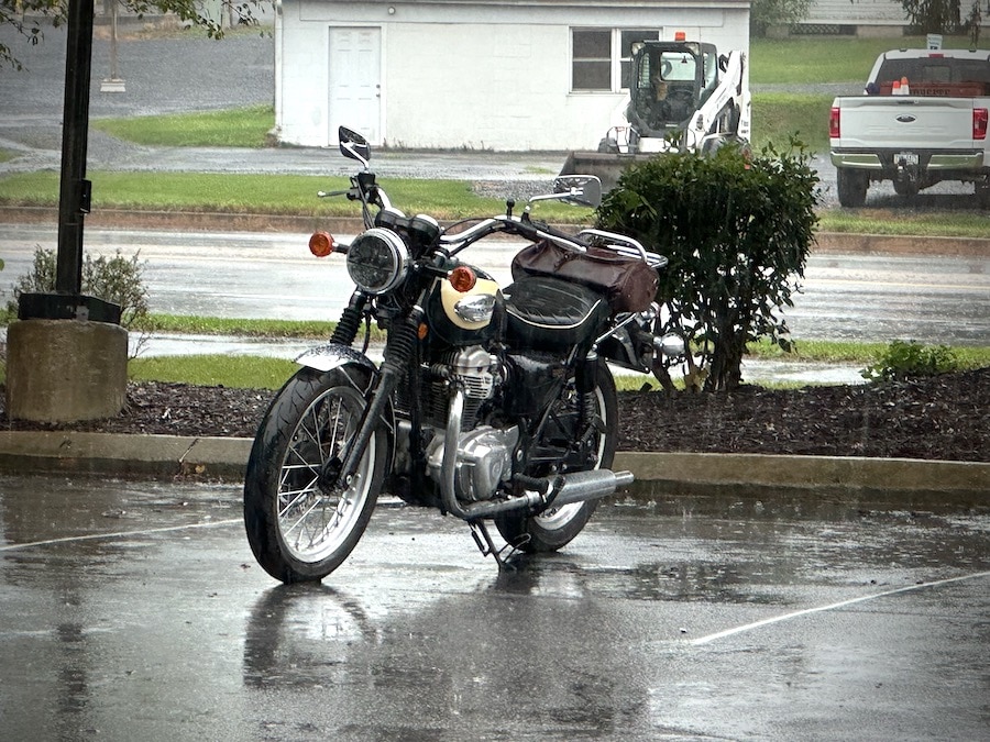 A 2001 Kawasaki W650 motorcycle parked in the rain.