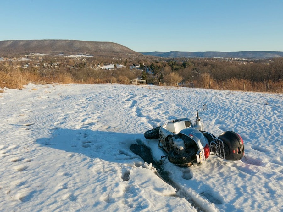 Vespa GTS scooter fallen in the snow.